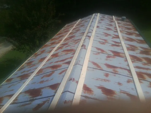 Rusted metal roof panels with new wood purlins before replacement — Storm Damage Roof Repair in Ledgewood by Roofing Brothers
