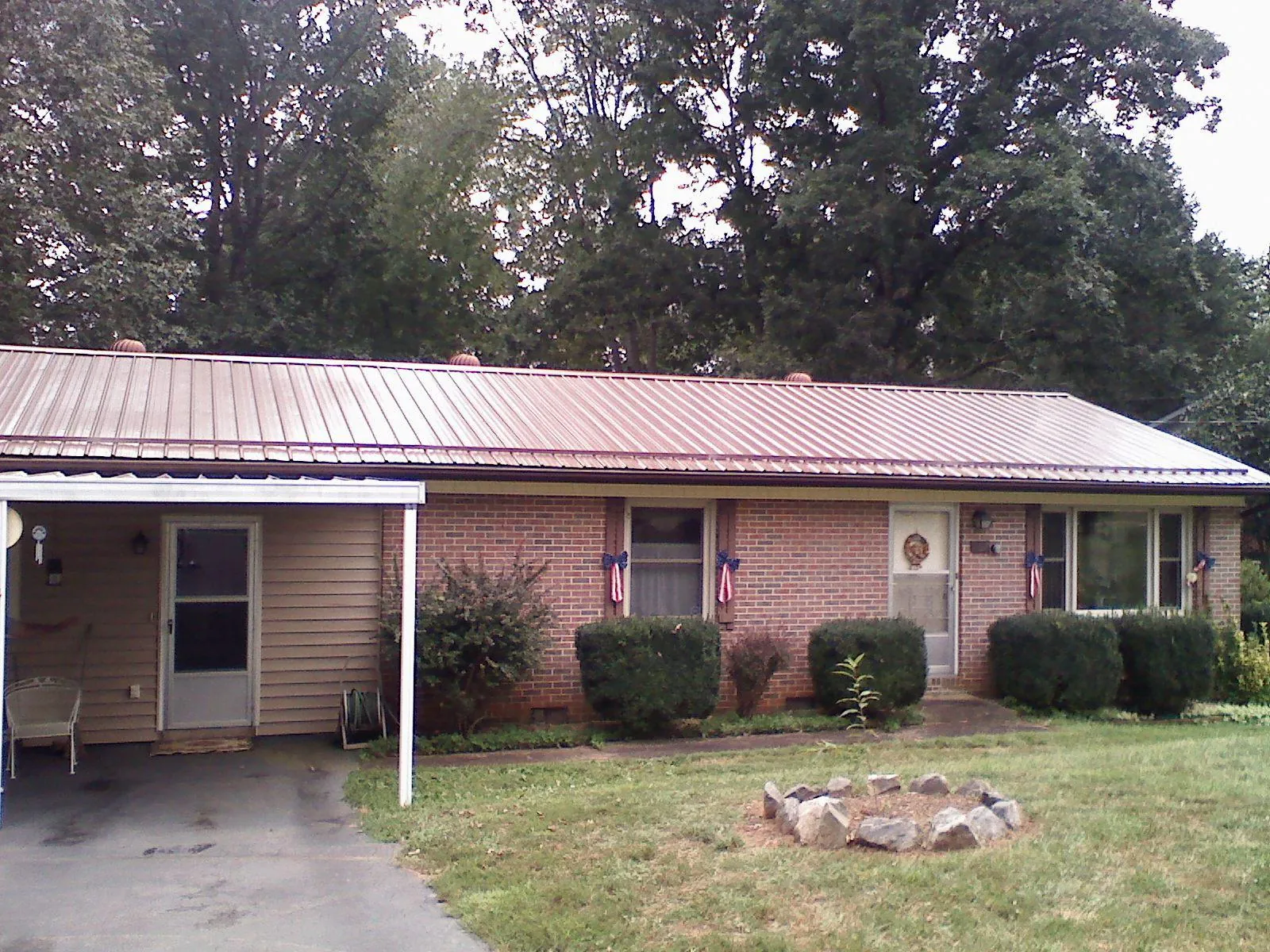 Bronze metal roof and carport on a brick ranch home — Roof Repair work by our crew in Ledgewood